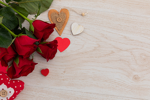 Bunch of red roses and hearts lying on wooden background. romance valentine's day flower nature freshness copy space.