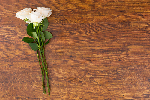 Bunch of white roses lying on wooden background. flower spring summer nature freshness copy space.