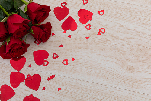 Bunch of red roses and red hearts lying on wooden background. romance valentine's day flower nature freshness copy space.
