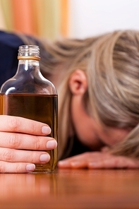 Woman sitting at home drinking way too much brandy|she is addicted