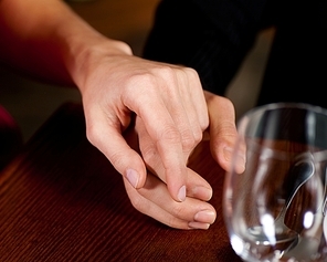 Couple holding hands on a table|probably in a restaurant