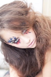 Artistic woman clown - creative art dramatic makeup. Body painting project