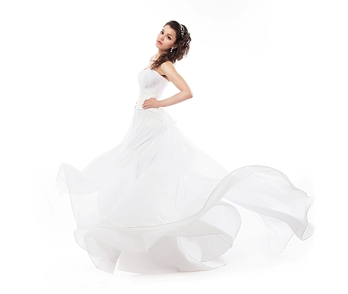 Brunette bride woman in bridal fashion white dress running - studio shot