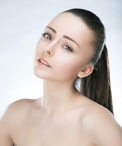 Beautiful young face of lovely woman with clean fresh skin and natural make up