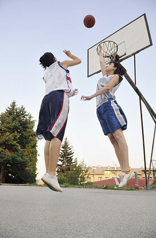 woman basketball player have treining and exercise at basketball court at city on street