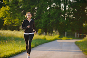 Young couple jogging in park at morning. Health and fitness.