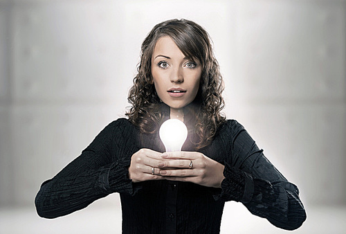 Young girl holding a light bulb