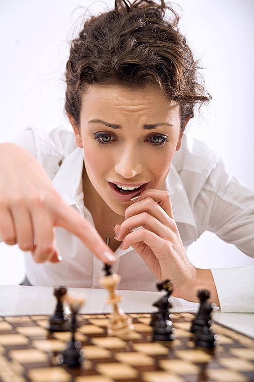 Young businesswoman playing chess
