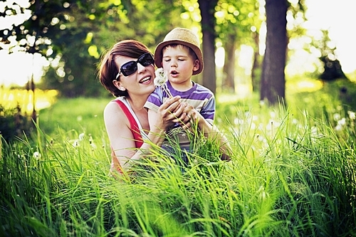 Colorful photo of mother and cute kid playing blow-balls