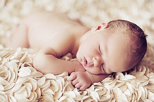 Picture presenting cute sleeping newborn baby