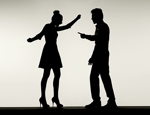 Two fighting silhouettes of the young marriage couple