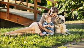 Mother hugging son and dog