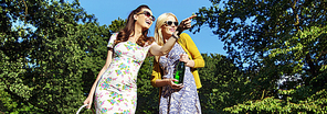 Two laughing ladies sightseeing a green park