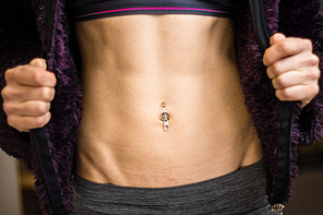 Athletic young woman with toned abs