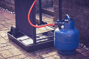 Barbecue and gas canister outside