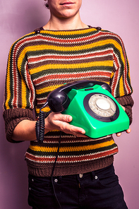 Young woman with an old rotary phone