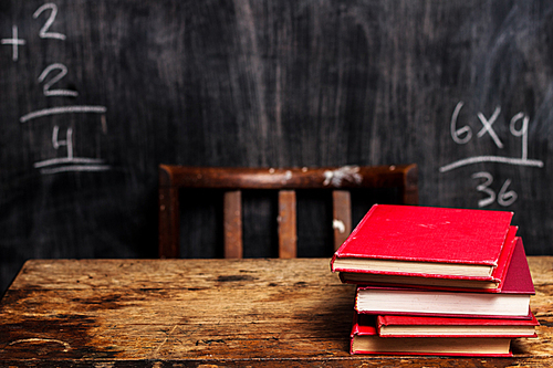 Book on desk with math in background