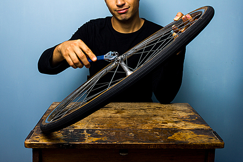 Man fixing bicycle wheel