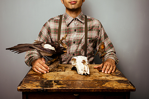 Woodsman at table with taxidermy display
