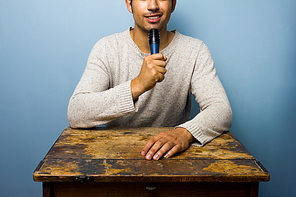 Man at table talking into microphone