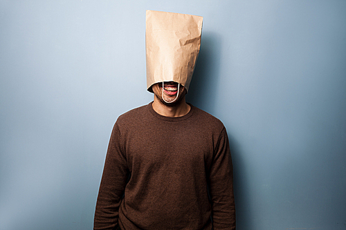 happy young man with a paper bag on his head