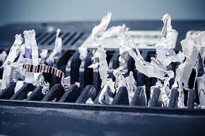 Close up on a cross shredder with paper