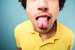 Young man is sticking his tongue out