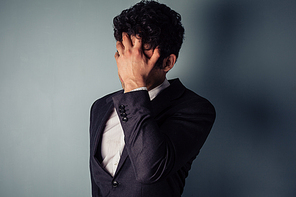 Stressed young businessman with a migraine