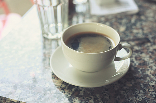 Cup of coffe on a table in a cafe scenario