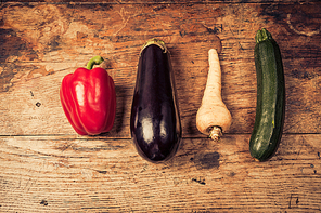 Red pepper|aubergine|parsnip and courgette on a wooden table
