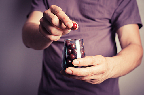 Closeup on a man offering candy from a small jar