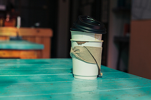 Stacked empty paper cups on a table in a cafe