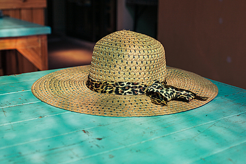 A straw hat on a table in the sunlight