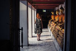 A young woman is exploring a buddhist temple