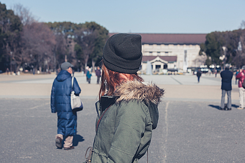 A young woman is walking in Ueno park in Tokyo