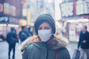 A young caucasian woman is wearing a face mask in Japan