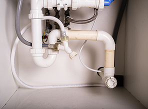 Piepes and plumbing under a kitchen sink