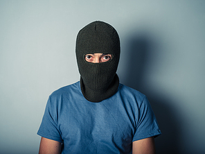 A scary young man is wearing a balaclava