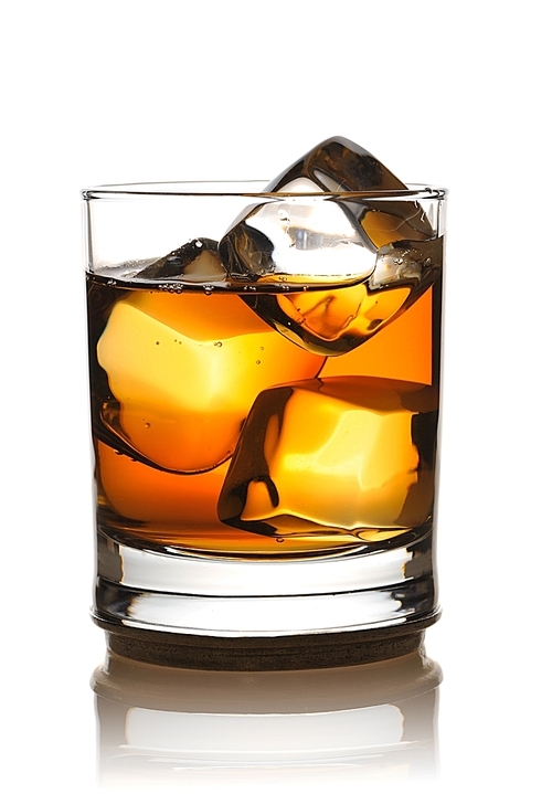 Single malt whiskey with ice isolated on white