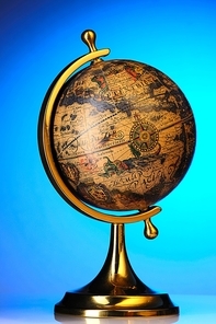 Old globe over blue background