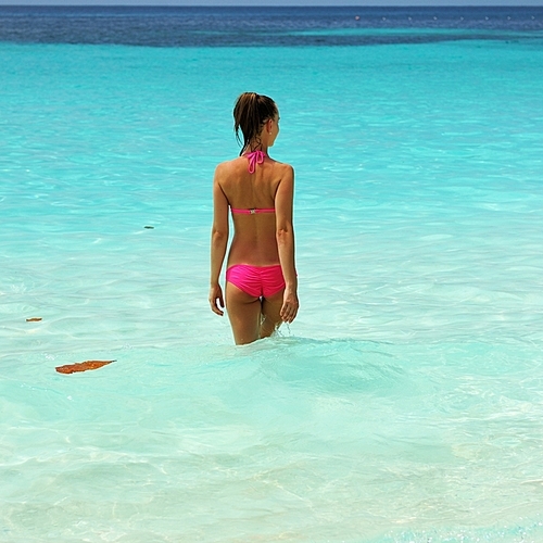 Woman in bikini at tropical beach