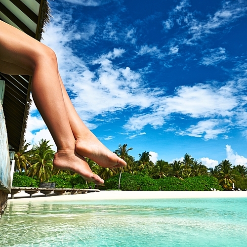 Woman's legs at beach jetty