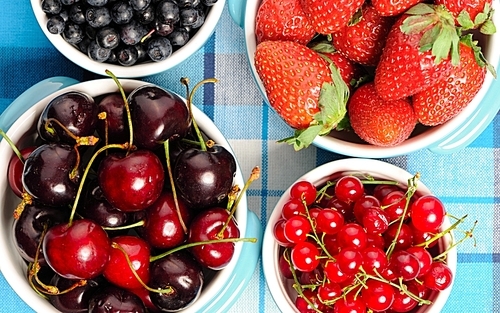 Wild berries in bowls - blueberry| redcurrant| cherry| strawberry