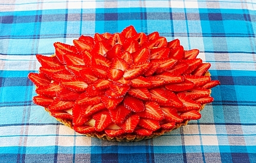 Homemade strawberry tart on table