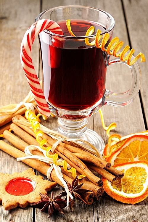 Glass of red mulled wine on wooden table