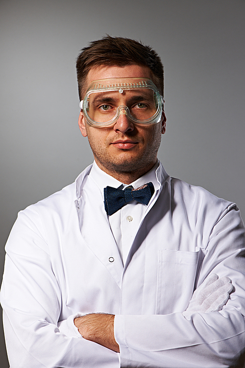 Scientist in yellow glasses against grey background