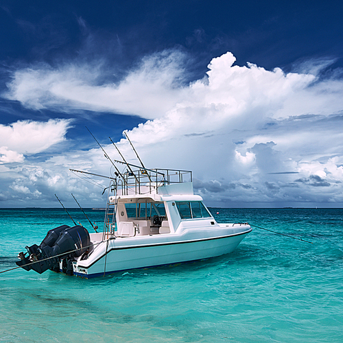 Beautiful island beach with motor boat at Maldives