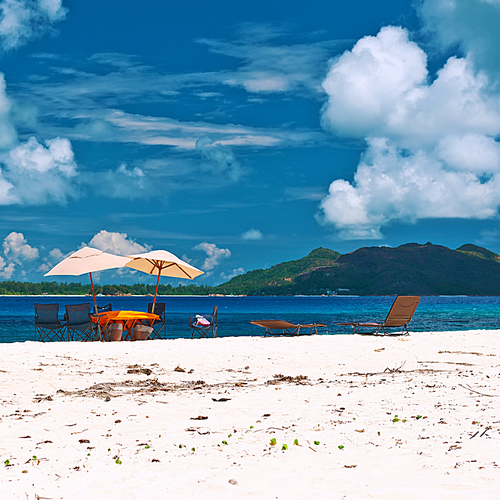 Tropical beach at Seychelles with picnic table and chairs