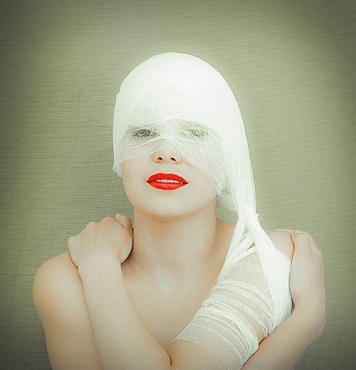 the beauty woman with red lips in bandage photo