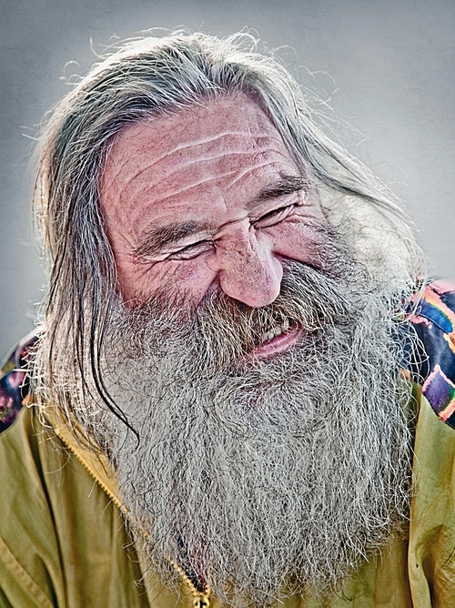 portrait of laughing old man with gray beard